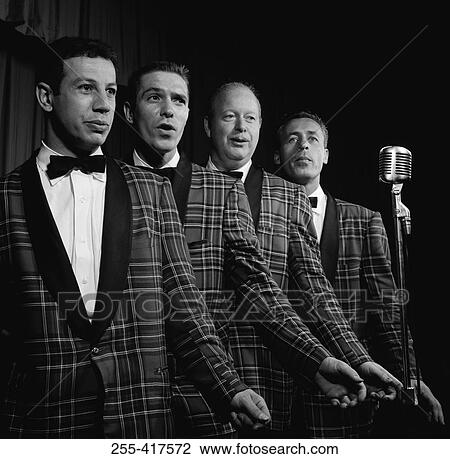 Four male singers performing on stage View Large Photo Image Stock Image - Four male singers performing on stage. Fotosearch