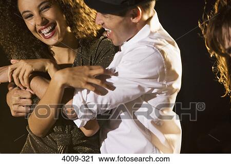Stock Image - Friends having fun in a party, Manhattan, New York City, New York State, USA. Fotosearch