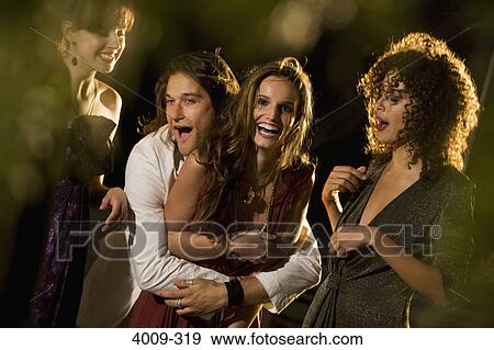Friends having fun in a party, Manhattan, New York City, New York State, USA View Large Photo Image Stock Photo - Friends having fun in a party, Manhattan, New York City, New York State, USA. Fotosearch