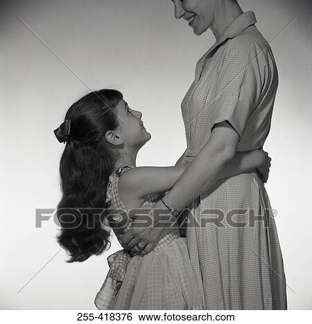 Girl embracing mother View Large Photo Image Stock Photograph - Girl embracing mother. Fotosearch