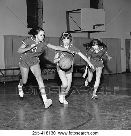Stock Image - Girls playing basketball. Fotosearch