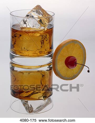 Glass of bourbon with an orange slice View Large Photo Image Stock Photography - Glass of bourbon with an orange slice. Fotosearch