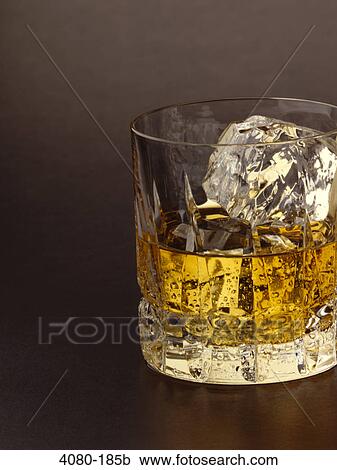 Glass of scotch with ice cube View Large Photo Image Stock Image - Glass of scotch with ice cube. Fotosearch