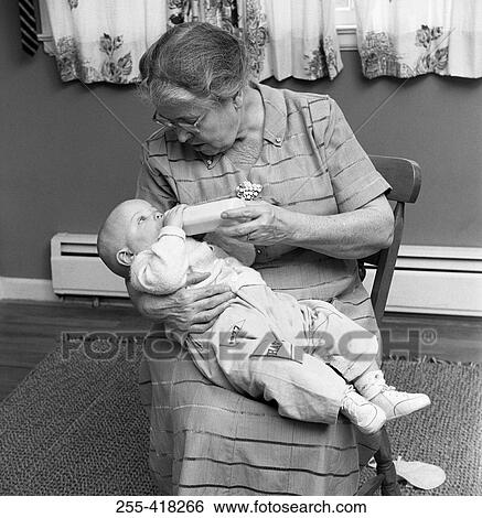 Stock Photograph - Grandmother feeding baby. Fotosearch