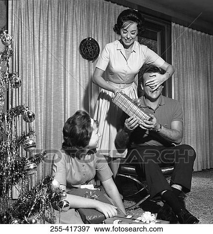 Stock Photo - Happy family opening Christmas presents. Fotosearch