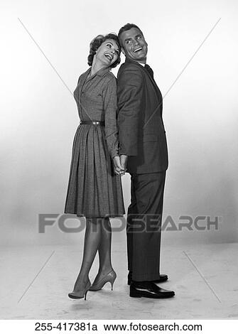 Happy mid adult couple holding hands, studio shot View Large Photo Image Stock Image - Happy mid adult couple holding hands, studio shot. Fotosearch