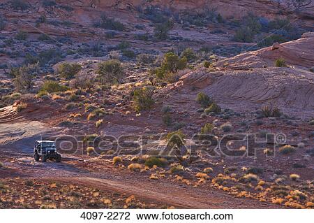 Stock Image - Jeep in a canyon, Poison Spyder Mesa, Moab, Utah, USA. Fotosearch