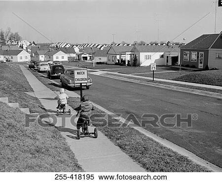 Stock Photography - Kids biking on tricycles. Fotosearch