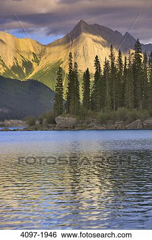Lake in front of mountains, Medicine Lake, Patricia Range, Canadian Rockies, Jasper National Park, Alberta, Canada View Large Photo Image Stock Photograph - Lake in front of mountains, Medicine Lake, Patricia Range, Canadian Rockies, Jasper National Park, Alberta, Canada. Fotosearch