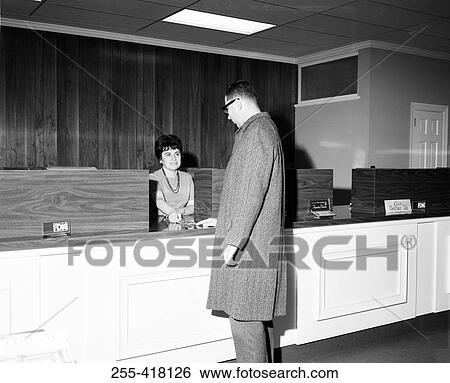 Stock Photograph - Man at hotel reception desk. Fotosearch