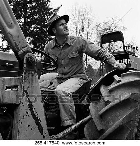 Stock Image - Man driving tractor. Fotosearch