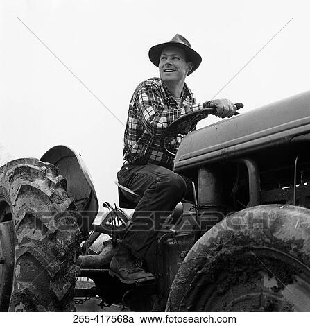 Man driving tractor View Large Photo Image Stock Image - Man driving tractor. Fotosearch