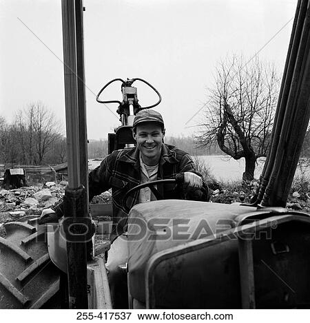 Stock Photo - Man driving tractor. Fotosearch