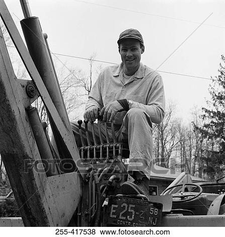 Stock Photo - Man driving tractor. Fotosearch