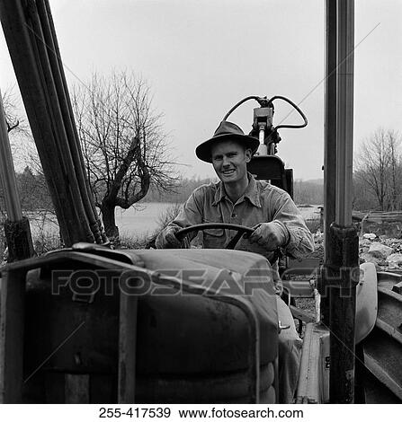 Man driving tractor View Large Photo Image Stock Photo - Man driving tractor. Fotosearch