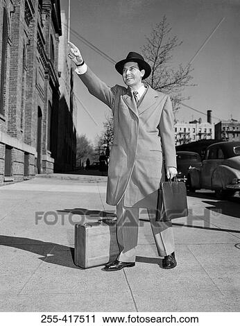 Man hailing for taxi in street View Large Photo Image Stock Image - Man hailing for taxi in street. Fotosearch
