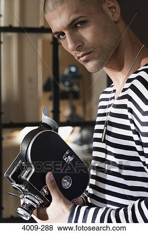 Man holding a video camera, Manhattan, New York City, New York State, USA View Large Photo Image Stock Photo - Man holding a video camera, Manhattan, New York City, New York State, USA. Fotosearch