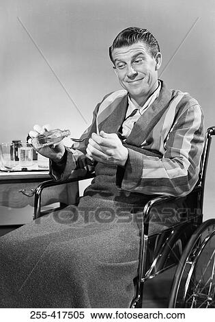 Man in wheelchair taking medicine View Large Photo Image Stock Photography - Man in wheelchair taking medicine. Fotosearch