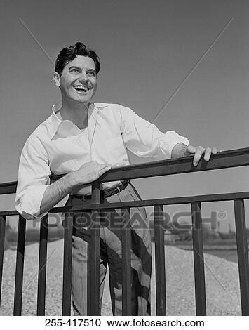 Man leaning on railing View Large Photo Image Stock Image - Man leaning on railing. Fotosearch