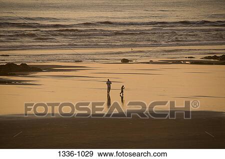 Man on the beach with his son, Oregon, USA View Large Photo Image Stock Photo - Man on the beach with his son, Oregon, USA. Fotosearch