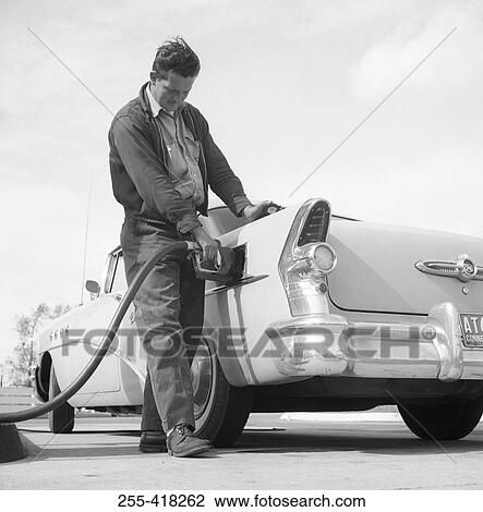 Man pouring petrol on gas station View Large Photo Image Stock Image - Man pouring petrol on gas station. Fotosearch