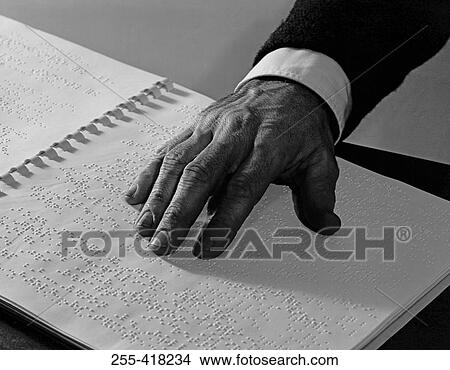 Picture - Man reading book in The Braille system. Fotosearch