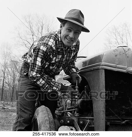 Man repairing tractor View Large Photo Image Stock Photograph - Man repairing tractor. Fotosearch