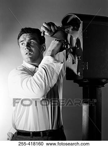 Stock Image - Man starting fire alarm. Fotosearch