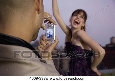 Man taking a picture of his girlfriend with a digital camera, Manhattan, New York City, New York State, USA View Large Photo Image Stock Image - Man taking a picture of his girlfriend with a digital camera, Manhattan, New York City, New York State, USA. Fotosearch