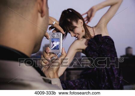 Man taking a picture of his girlfriend with a digital camera, Manhattan, New York City, New York State, USA View Large Photo Image Stock Image - Man taking a picture of his girlfriend with a digital camera, Manhattan, New York City, New York State, USA. Fotosearch