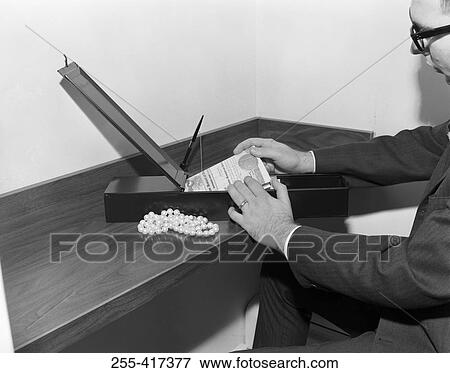 Man taking things out from safe deposit box in a bank View Large Photo Image Stock Photo - Man taking things out from safe deposit box in a bank. Fotosearch