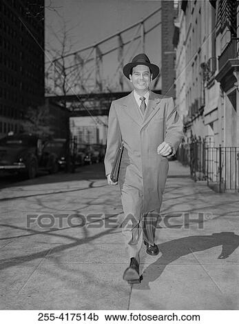 Man walking down street View Large Photo Image Stock Image - Man walking down street. Fotosearch
