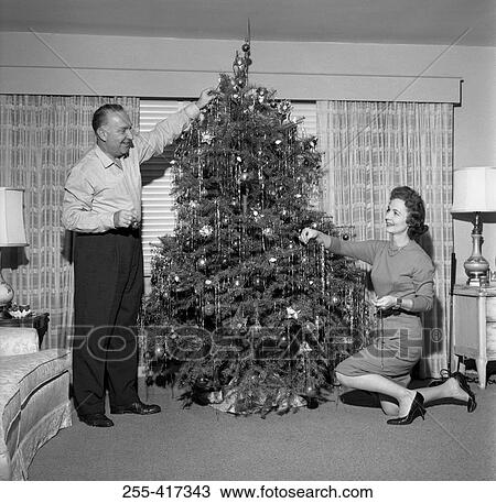Mature couple decorating Christmas tree View Large Photo Image Stock Image - Mature couple decorating Christmas tree. Fotosearch