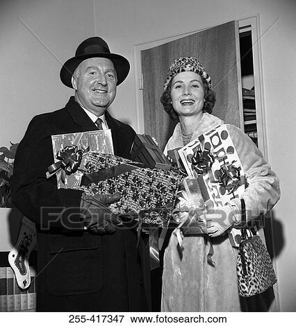 Stock Photo - Mature couple with Christmas gifts. Fotosearch