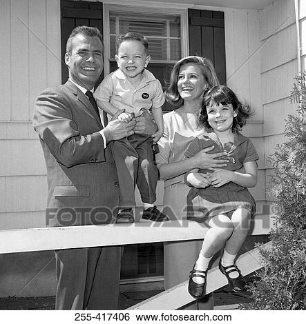 Mature couple with two children in front of the house View Large Photo Image Stock Photograph - Mature couple with two children in front of the house. Fotosearch