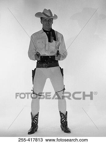 Mature cowboy holding guns View Large Photo Image Stock Image - Mature cowboy holding guns. Fotosearch