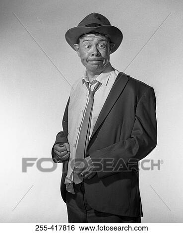 Mature man standing and making funny face View Large Photo Image Stock Photograph - Mature man standing and making funny face. Fotosearch