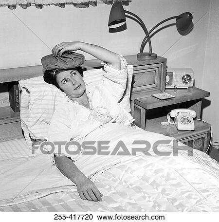 Mature woman reclining in bed with headache View Large Photo Image Stock Image - Mature woman reclining in bed with headache. Fotosearch