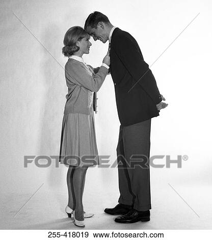 Mid adult couple standing face to face and smiling View Large Photo Image Stock Photo - Mid adult couple standing face to face and smiling. Fotosearch