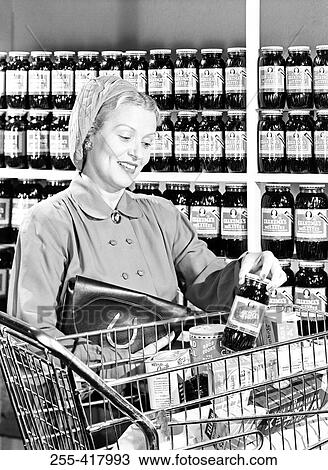 Stock Image - Mid adult woman shopping. Fotosearch
