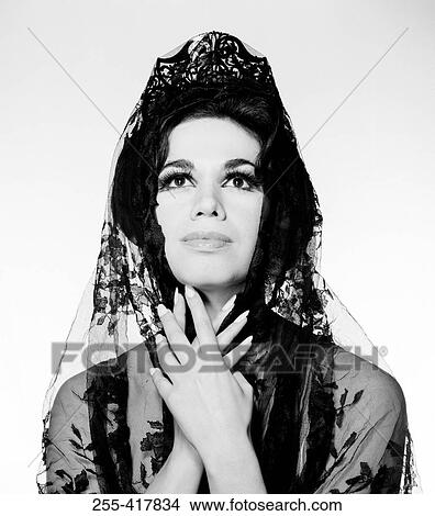 Mid adult woman wearing black veil looking up View Large Photo Image Picture - Mid adult woman wearing black veil looking up. Fotosearch