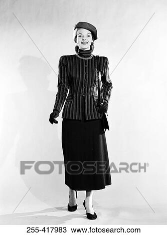 Mid adult woman wearing skirt, jacket and hat View Large Photo Image Stock Image - Mid adult woman wearing skirt, jacket and hat. Fotosearch