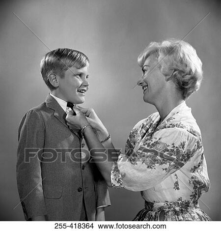 Picture - Mother adjusting tie to son. Fotosearch