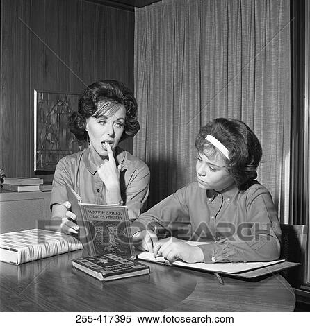 Stock Photography - Mother helping daughter in homework. Fotosearch