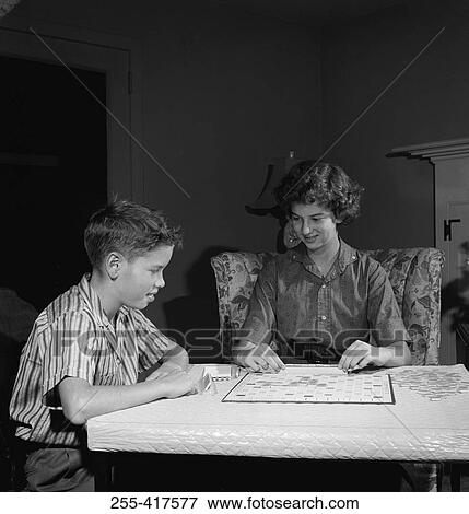 Stock Photo - Mother playing scrabble with son in home. Fotosearch