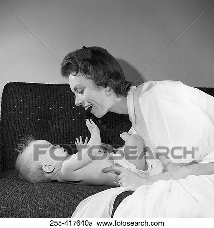 Mother with baby boy on sofa View Large Photo Image Stock Image - Mother with baby boy on sofa. Fotosearch