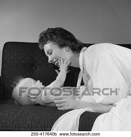 Mother with baby boy on sofa View Large Photo Image Stock Image - Mother with baby boy on sofa. Fotosearch