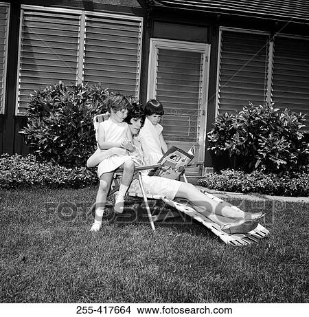 Mother with children reading in garden View Large Photo Image Picture - Mother with children reading in garden. Fotosearch
