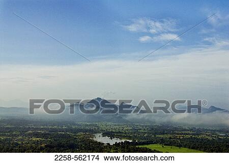 Mountain surrounded by clouds, Sigiriya, Matale District, Sri Lanka View Large Photo Image Picture - Mountain surrounded by clouds, Sigiriya, Matale District, Sri Lanka. Fotosearch