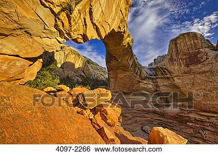 Stock Photograph - Natural arch in a canyon, Hickman Bridge, Capitol Reef National Park, Utah, USA. Fotosearch